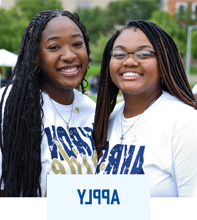 Two UA students smiling wearing Akron Pride T-shirts